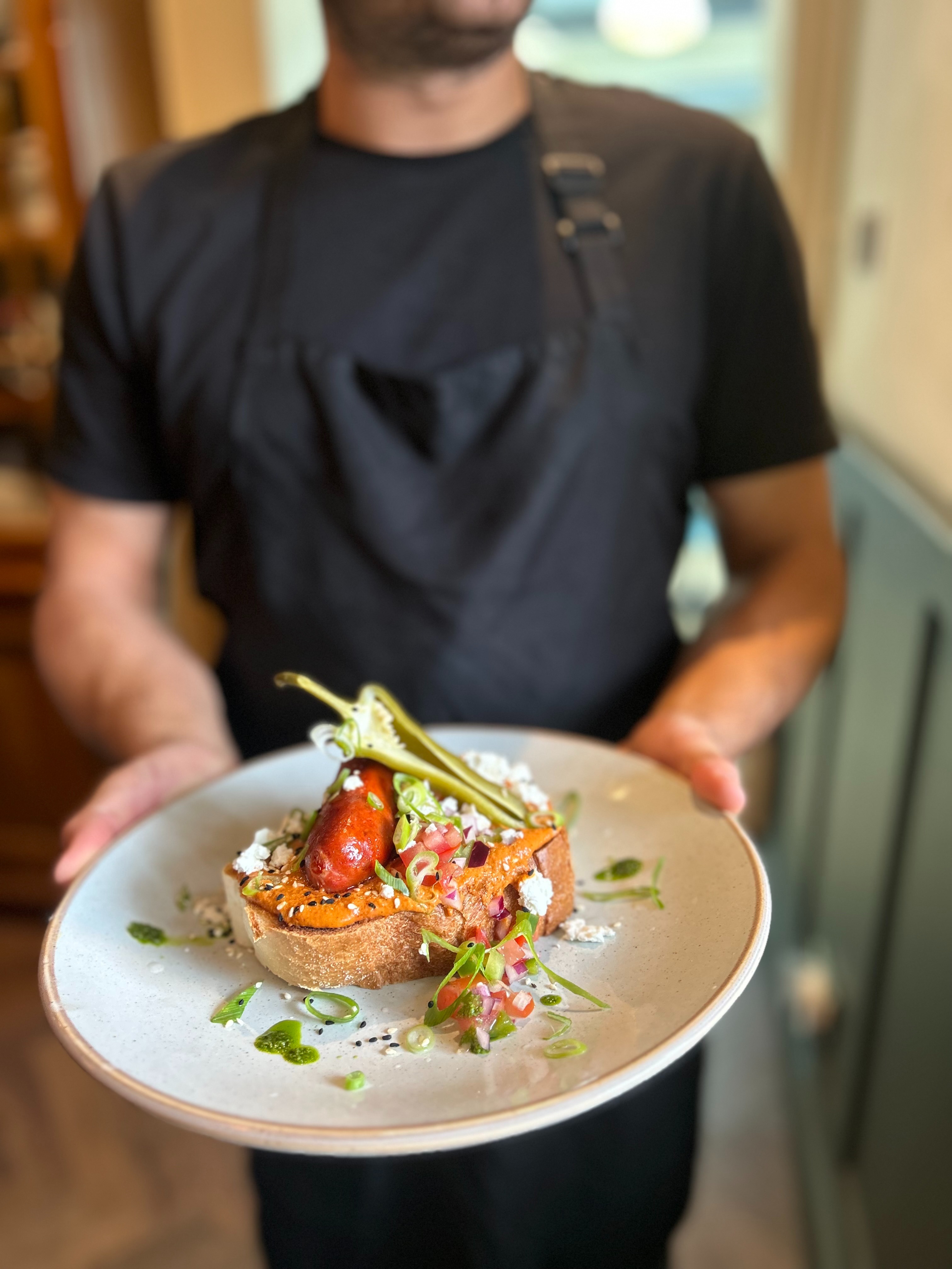 A chef preparing a brunch dish at Joni